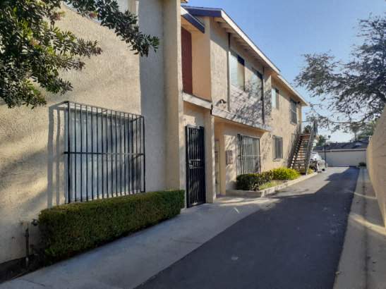 A row of houses with black iron gates.